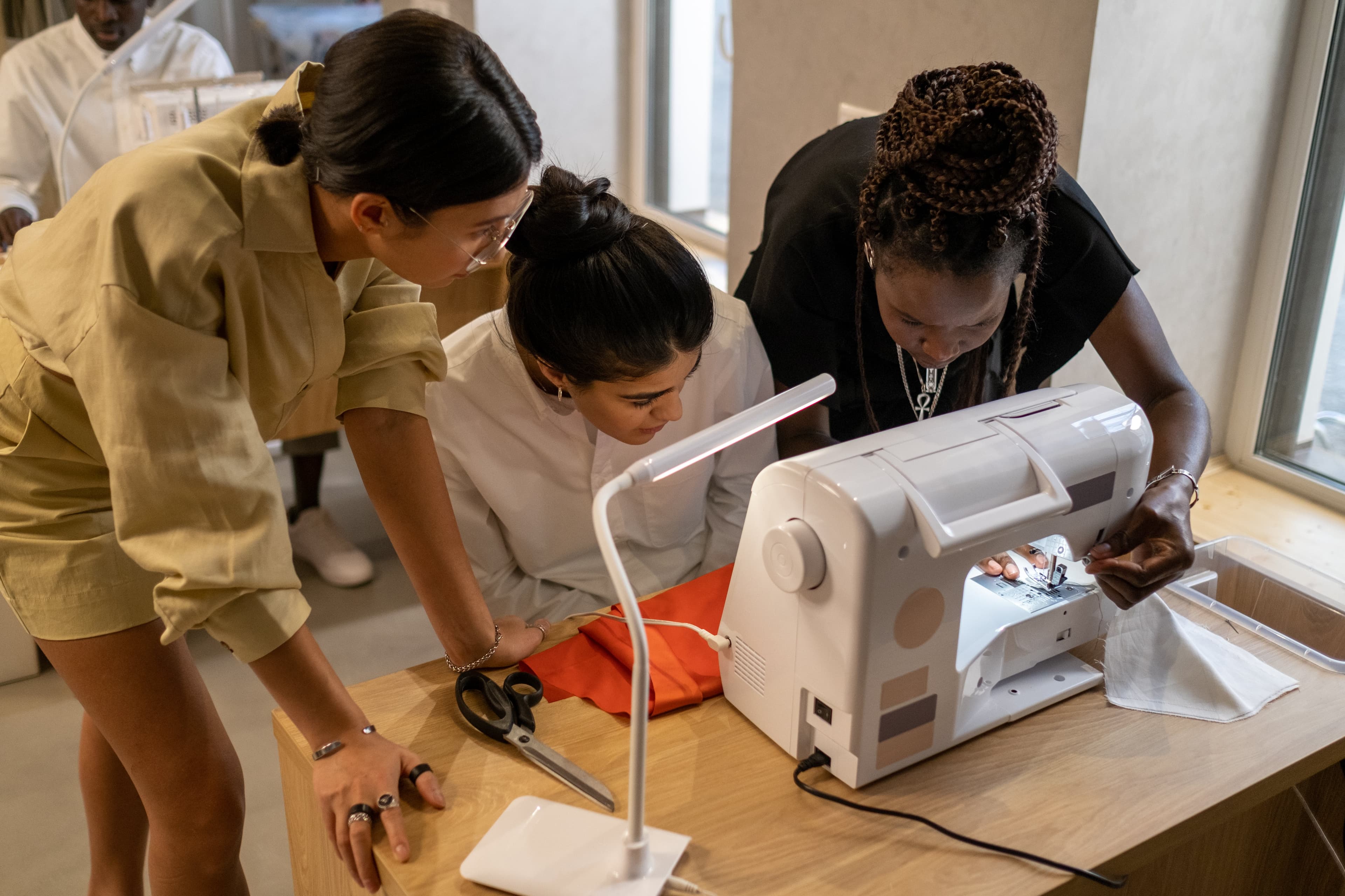 photo showing a fashion designer making sketches